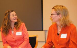 women wearing orange shirts and name badges