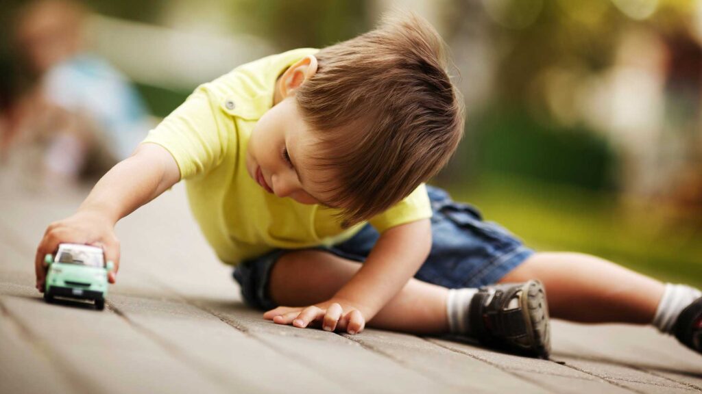 a child crawling on a wood deck