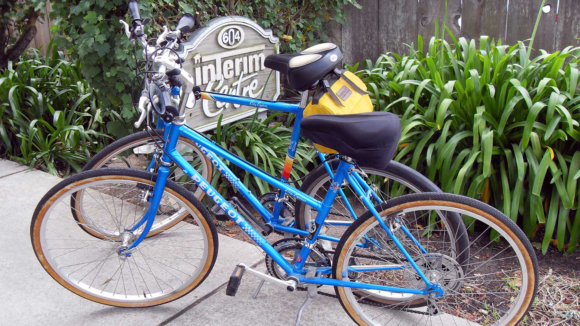 a blue bicycle parked on a sidewalk