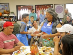 volunteers serve guests holiday meals