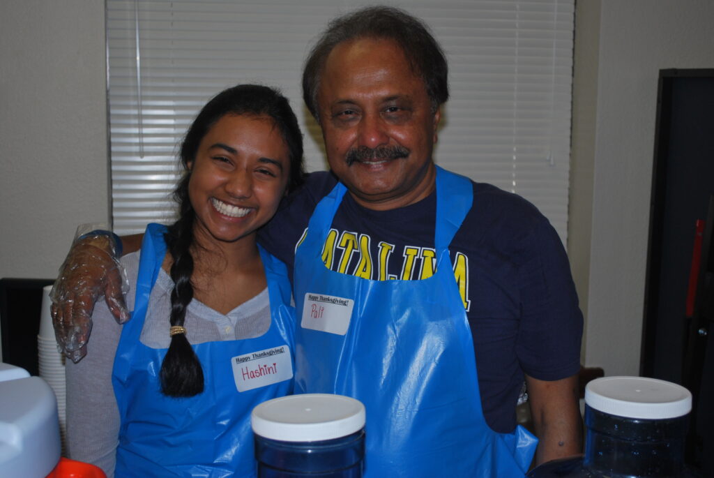 a man and woman wearing blue aprons