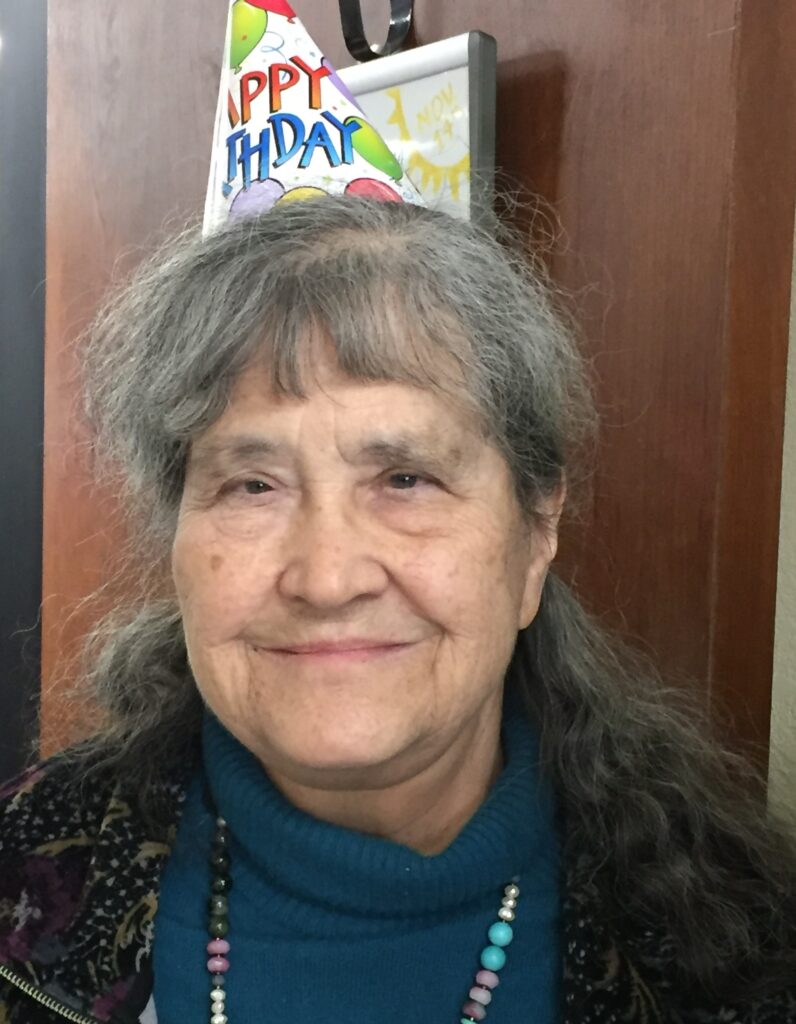 a woman wearing a birthday hat