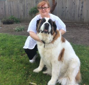 a woman holding a large dog