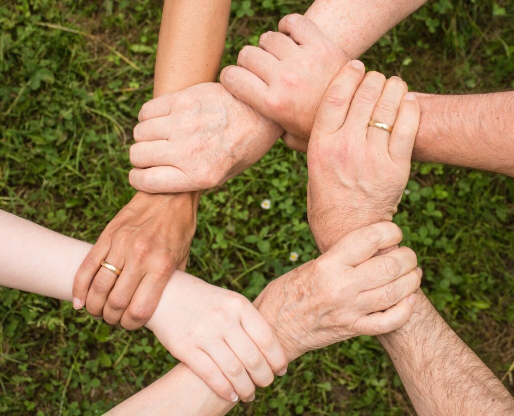 To Give is To Receive, April 15-21! Interim Celebrates the Our Voices Volunteers! 5 a group of hands holding each other