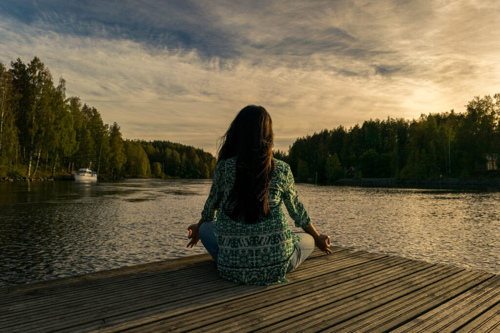 October 2nd! Annual Wellness and Recovery Conference 5 a woman sitting on a dock near water