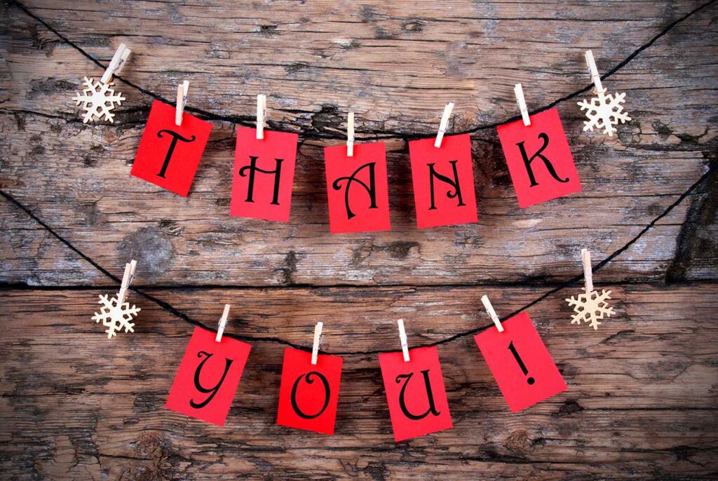 Thank You Interim Donors!!! 9 red cards with black writing on them and a clothespin attached to a string