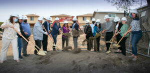 a group of people wearing white helmets and shovels