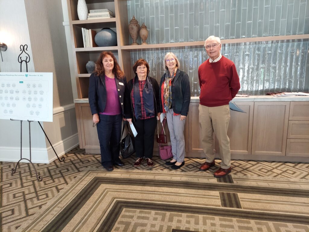 Maureen and Wayne Lavengood Honored by Interim on National Philanthropy Day 11 a group of people standing in a room