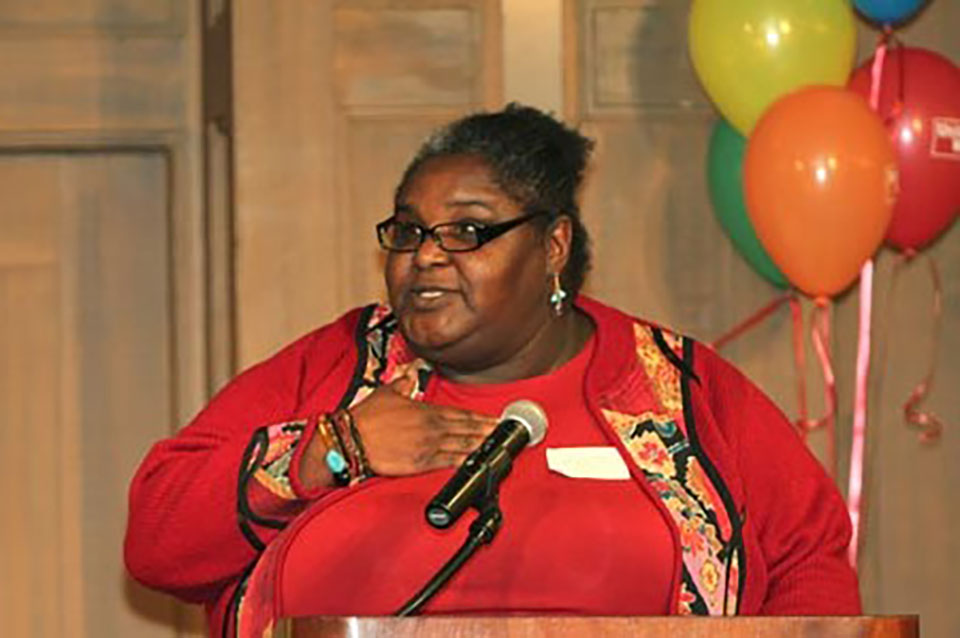 a woman standing at a podium with a microphone