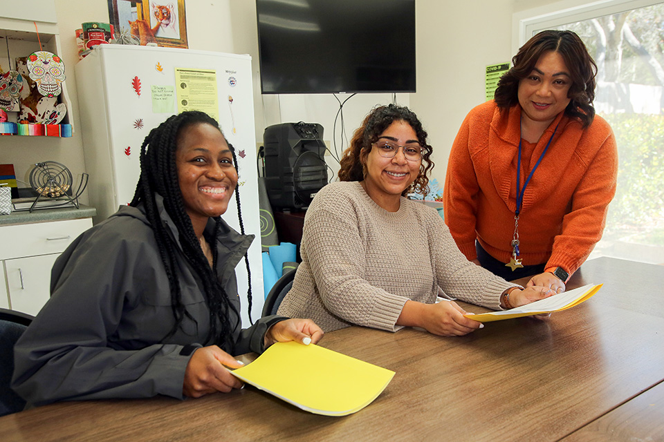 a group of women smiling at a table