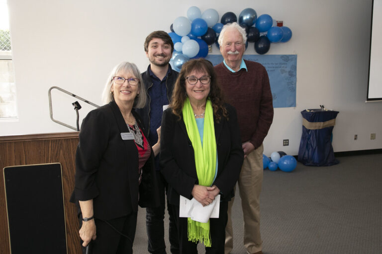 a group of people standing in front of a podium