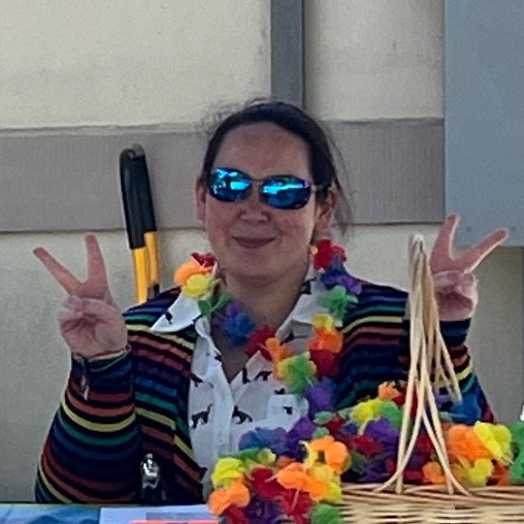 Staff member gesturing peace signs