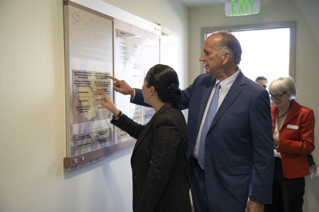 a man and woman looking at a board