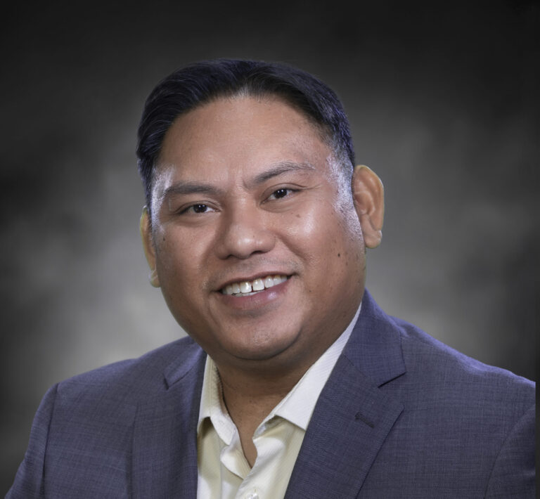 a man in a suit smiling