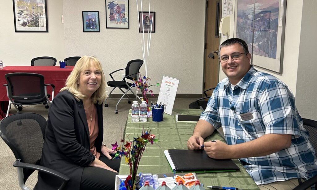 a man and woman sitting at a table