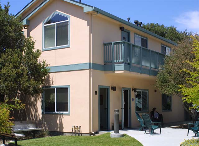 a house with a balcony and a bench