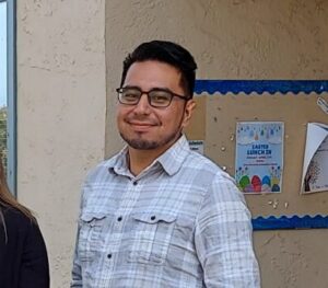 a man wearing glasses and a plaid shirt