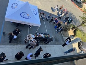 a group of people standing outside a tent