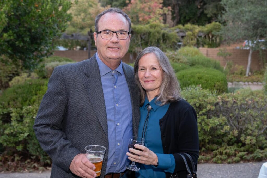 a man and woman holding drinks