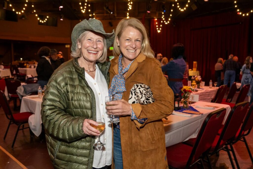 two women holding wine glasses