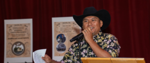 a man in a cowboy hat holding a microphone