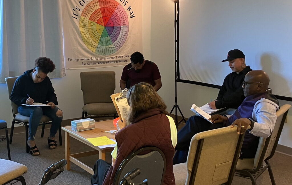 a group of people sitting in chairs in a room