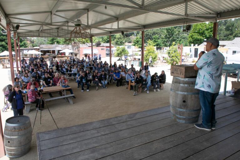 a man speaking to a crowd of people